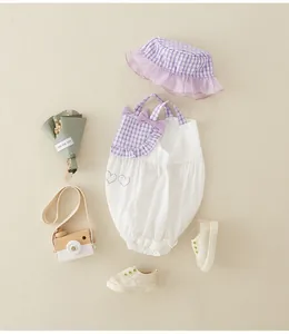 Infant cotton bodysuit and sun hat set with purple plaid accents and bow detail