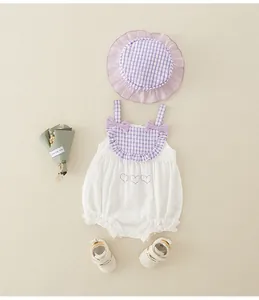 Detail of infant cotton bodysuit with lavender plaid bow and matching ruffled sun hat