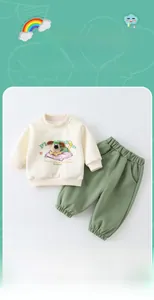 Detail view of cotton toddler tracksuit featuring dog embroidery and green jogger pants