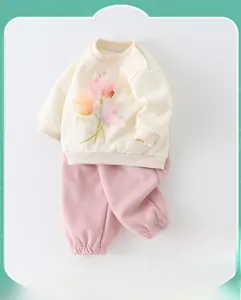 Close-up of baby spring cotton set showing tulip print and shoulder snap buttons