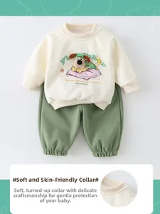 Detail of baby sweatshirt neckline with snaps and soft plush cartoon puppy decoration
