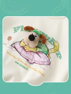 Detail of 3D plush puppy and embroidered lettering on off-white cotton sweatshirt