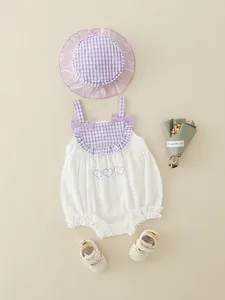 Infant girl cotton romper set with purple checkered pattern and matching sun hat