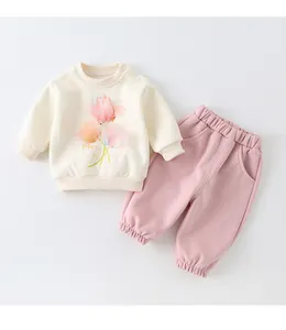 Close-up of baby cotton sweatshirt set with pink floral print and elastic waist trousers