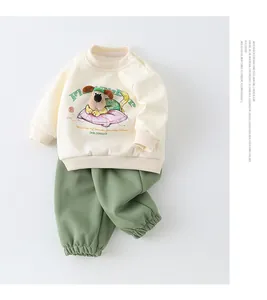 Close-up of cotton baby sweatshirt with cartoon animal embroidery and green joggers