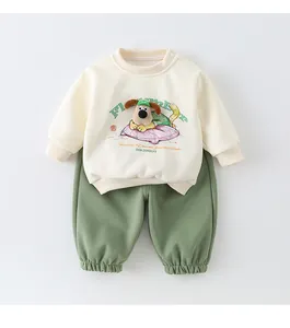 Flat lay of cotton infant sweatshirt set with beige puppy embroidery and green pants