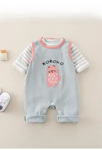Detail of baby waffle knit romper with Momoko embroidery and striped faux layering