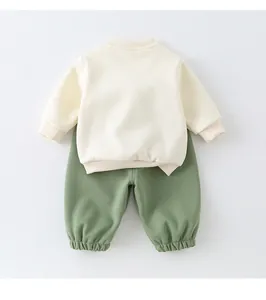 Detailed flat lay of soft cotton two-piece baby tracksuit with sweatshirt and pants