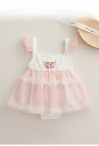 Detail of baby girl cotton romper with pink mesh skirt and 3D bow accent