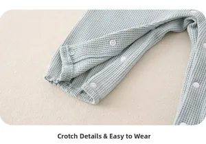 Close-up of light blue waffle knit baby romper with convenient crotch resin snap buttons