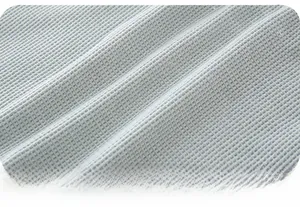 Macro close-up of soft light blue waffle knit fabric texture for baby clothing set