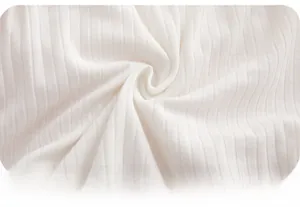 Detailed macro view of pure white ribbed cotton fabric showing soft texture and elasticity