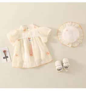 Dettaglio pagliaccetto cinese per neonata con ricami e nappe rosa decorative