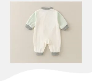 Detail view of baby cotton romper featuring contrast sleeves and striped ribbed cuffs