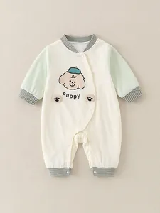 Long-sleeved cotton baby romper with puppy print and green sleeves on beige background