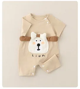 Close-up of baby romper showing cotton fabric texture, snaps and a cute lion applique