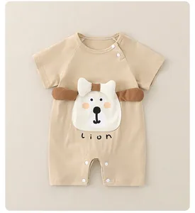 Close-up of baby cotton romper featuring cartoon lion face and 3D ear details