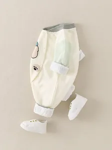 Infant cotton bodysuit with long green sleeves and cartoon pattern in cream white