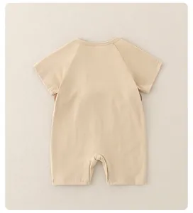 Detailed back view of a minimalist cotton baby bodysuit with raglan short sleeves in beige