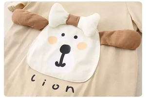 Detailed macro view of soft cotton baby romper with a cute lion print and 3D bow detail