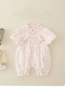 Detail of pink floral baby romper with traditional Chinese knot and lace collar