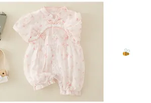 Detailed view of light pink floral baby romper with traditional Chinese frog buttons