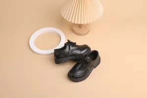 Classic black boys brogue shoes with decorative perforations and durable non-slip soles