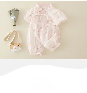 Detail of pink floral baby romper with traditional Chinese knot and lace embellishments