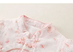 Detailed view of baby girl romper with floral embroidery, mandarin collar and frog button