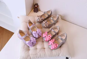 Close-up of glitter girls' princess shoes in purple, silver, and champagne gold colors