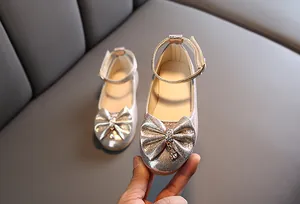 Silver glitter girls shoes with rhinestone bow and dangling heart crystal detail