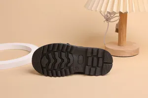 Detailed view of size 28 children's black leather shoe with non-slip rubber sole