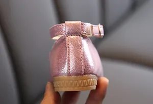 Close-up of the pink glitter fabric stitching and brown non-slip rubber sole details