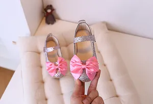Detailed close-up of pink sequined Mary Jane shoes for girls with large satin bow