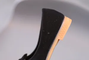 Dettaglio macro della scarpa in pelle scamosciata nera con suola in gomma antiscivolo