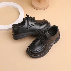 Classic black boys' brogue shoes with perforated wingtip details and anti-slip rubber soles