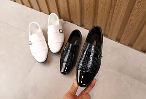 Detail of boys' formal dress shoes featuring woven texture and shiny patent leather