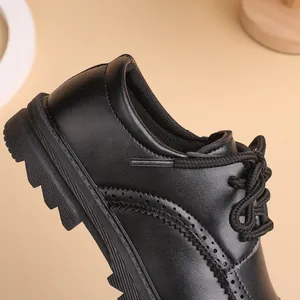 Classic black leather brogue shoes for boys with elegant carving and lace-up design