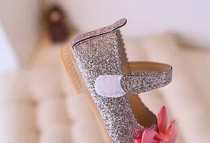 Detail of pink glitter Mary Jane shoes with satin bow and non-slip rubber sole