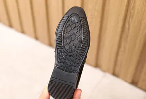 Detailed macro view of non-slip rubber sole for children leather shoes in size 30
