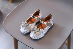 Detail of girls' princess shoes with purple sequins, rhinestones, and mesh bow decoration
