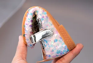 Close-up showing the flexible rubber sole and colorful sequins of the Mary Jane shoe
