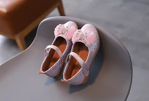 Detail of pink sequin Mary Jane shoes for girls with crystal bow and velcro strap