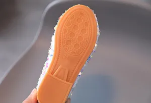 Detailed view of durable orange rubber anti-slip sole with honeycomb pattern and size 28 stamp