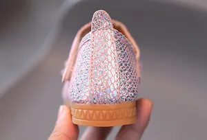 Detail of pink sequin girls shoes showing glitter scale texture and non-slip rubber sole