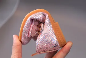 Pink glitter girls princess shoe showing the flexible and soft rubber sole in detail