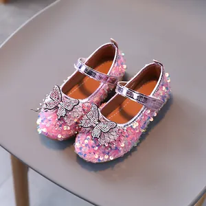 Pink sequin Mary Jane shoes for girls featuring a rhinestone butterfly and velcro strap