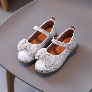 Shiny silver sequined Mary Jane princess shoes with pearl and rhinestone bow detail