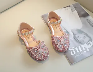 Vue détaillée des chaussures de princesse roses avec strass scintillants et nœuds