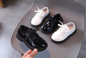 Detail of glossy patent leather kids' oxfords with anti-slip thick rubber soles